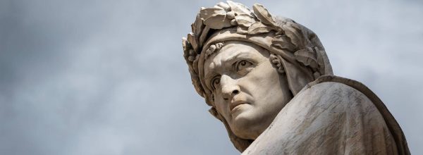 Closeup shot of the famous white marble monument of Dante Alighieri by  Enrico Pazzi in Piazza Santa Croce, next to Basilica of Santa Croce, Florence, Italy on a moody sky background