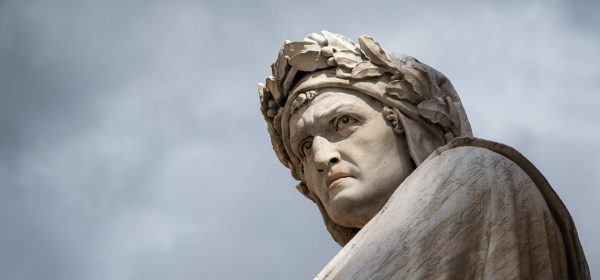 Closeup shot of the famous white marble monument of Dante Alighieri by  Enrico Pazzi in Piazza Santa Croce, next to Basilica of Santa Croce, Florence, Italy on a moody sky background